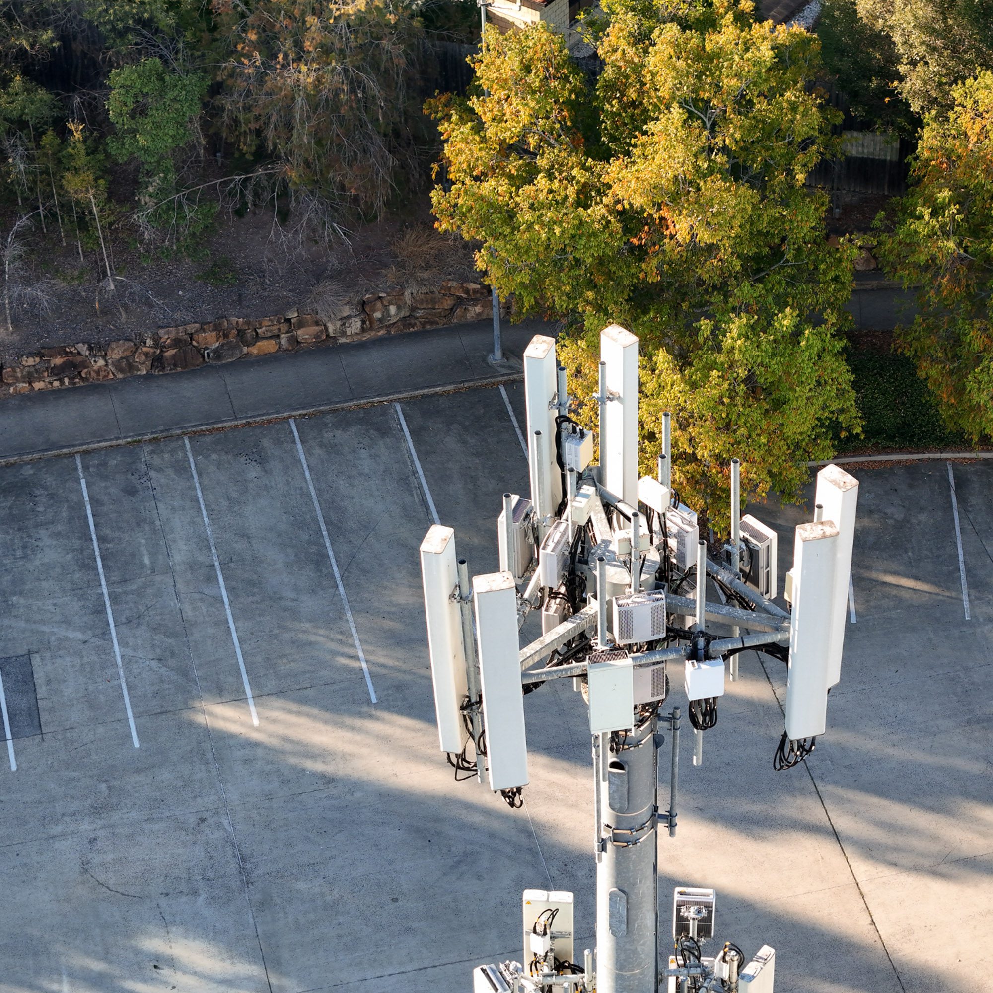 Cell tower in an empty parking lot.